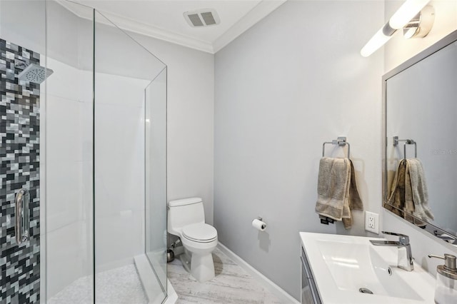 bathroom featuring vanity, toilet, ornamental molding, and a tile shower