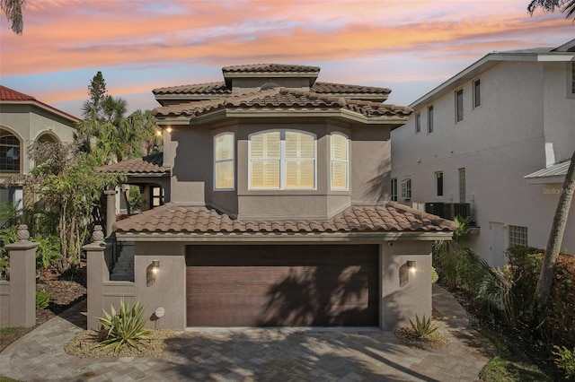 mediterranean / spanish-style house with a garage