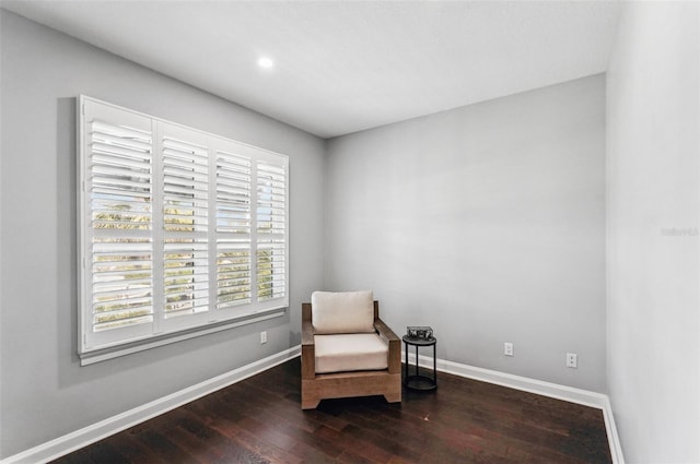 living area featuring dark wood-style floors and baseboards