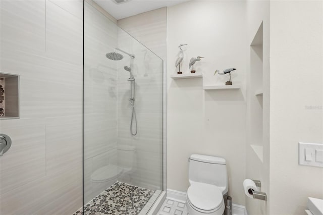 full bathroom featuring a shower stall and toilet