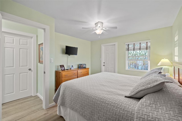 bedroom with ceiling fan and light hardwood / wood-style floors