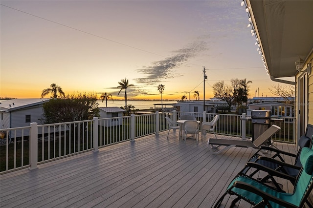 deck at dusk with grilling area