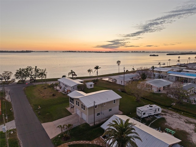 aerial view at dusk with a water view