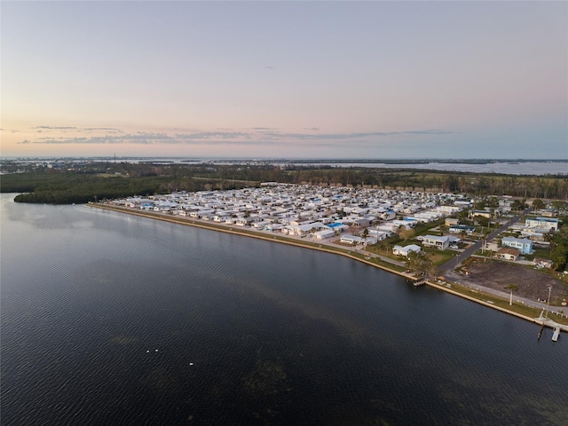 aerial view at dusk with a water view