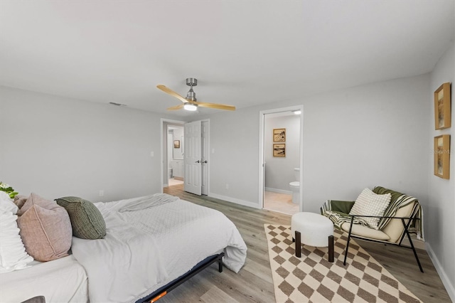 bedroom featuring connected bathroom, ceiling fan, and light hardwood / wood-style floors