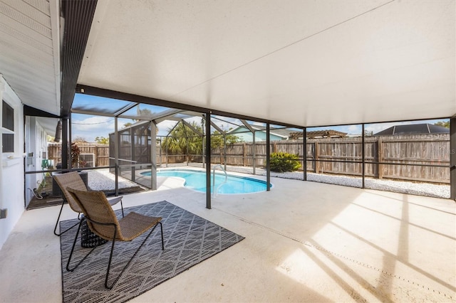 view of swimming pool featuring glass enclosure and a patio area