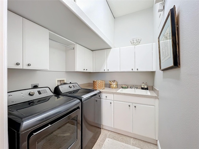 clothes washing area featuring cabinets, light tile patterned floors, separate washer and dryer, and sink