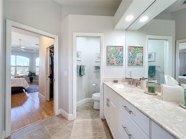 bathroom with tile patterned floors, ceiling fan, toilet, and vanity