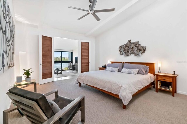 bedroom featuring ceiling fan, carpet flooring, and beamed ceiling