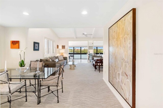 carpeted dining area featuring vaulted ceiling with beams, ceiling fan, and recessed lighting