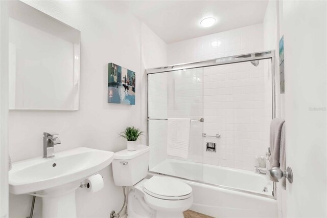 bathroom with toilet, a sink, and bathing tub / shower combination