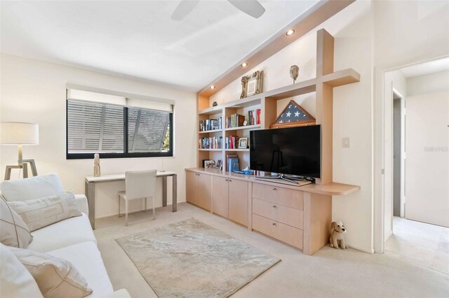 living room with a ceiling fan, light colored carpet, vaulted ceiling, built in shelves, and recessed lighting