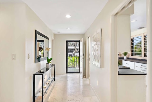 entryway with recessed lighting, a healthy amount of sunlight, and baseboards