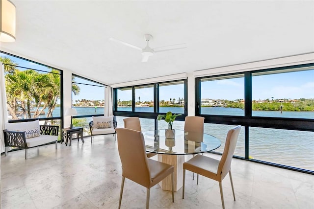 sunroom featuring a water view and plenty of natural light