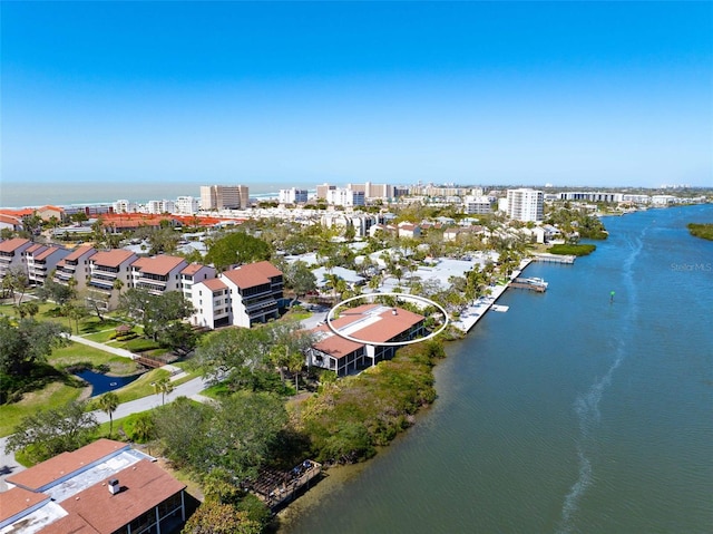 birds eye view of property featuring a water view and a view of city