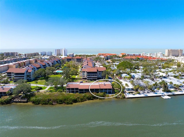 birds eye view of property featuring a view of city and a water view