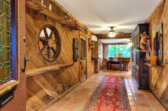 interior space featuring tile patterned flooring, a wall mounted air conditioner, and wooden walls