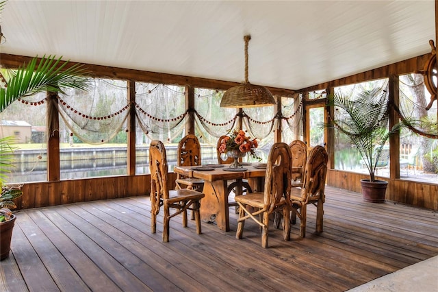 sunroom / solarium featuring a wealth of natural light and vaulted ceiling