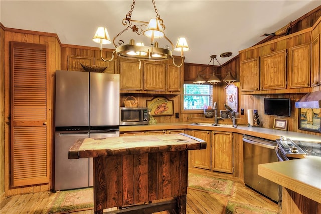 24120 Mink Rd, Astor, FL 32102 - kitchen with appliances with stainless steel finishes, light wood-style flooring, a kitchen island, decorative light fixtures, and wood counters