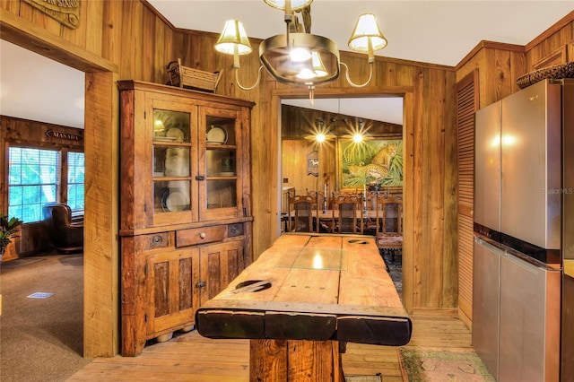 24120 Mink Rd, Astor, FL 32102 - dining room featuring wooden walls and light wood-style floors