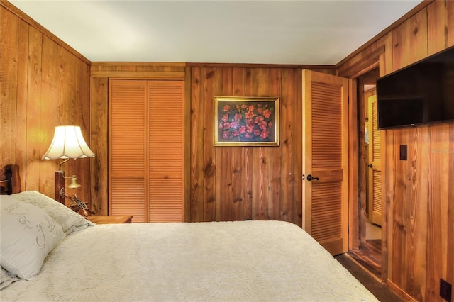 bedroom with wood walls and carpet floors