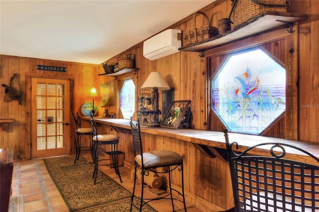 bar featuring a wall unit AC and wooden walls