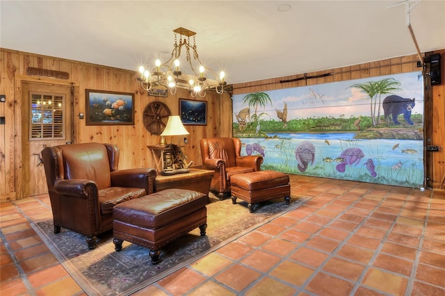 sitting room featuring tile patterned floors, a notable chandelier, and wooden walls