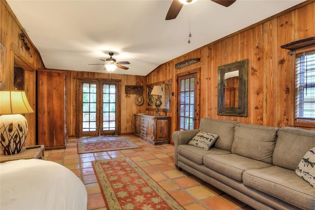 24120 Mink Rd, Astor, FL 32102 - living room featuring a ceiling fan, wood walls, french doors, and healthy amount of natural light