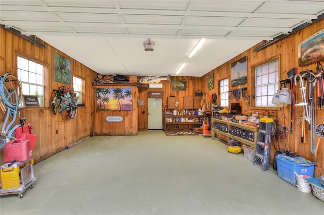 24120 Mink Rd, Astor, FL 32102 - garage featuring wood walls, a workshop area, and a garage door opener