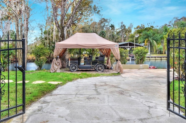 view of parking / parking lot with a gazebo and a water view