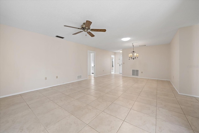 tiled spare room with a textured ceiling and ceiling fan with notable chandelier