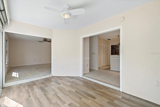 spare room featuring ceiling fan and light wood-type flooring