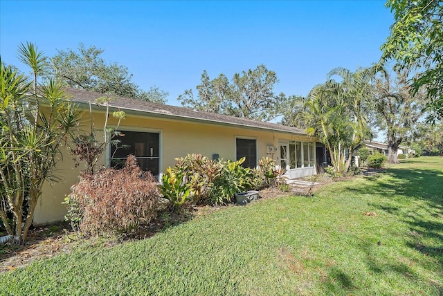 rear view of property featuring a yard