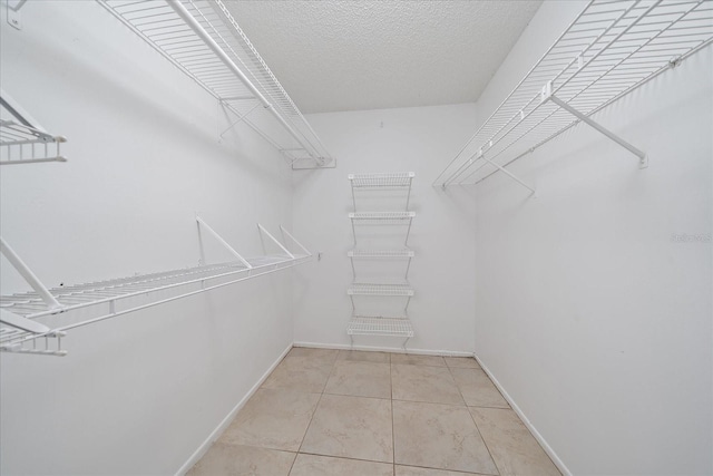 spacious closet with tile patterned flooring