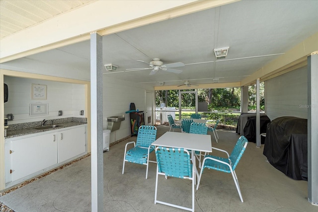 sunroom with ceiling fan and sink