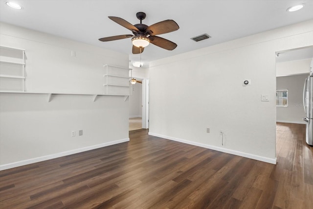 unfurnished living room with ceiling fan and dark wood-type flooring