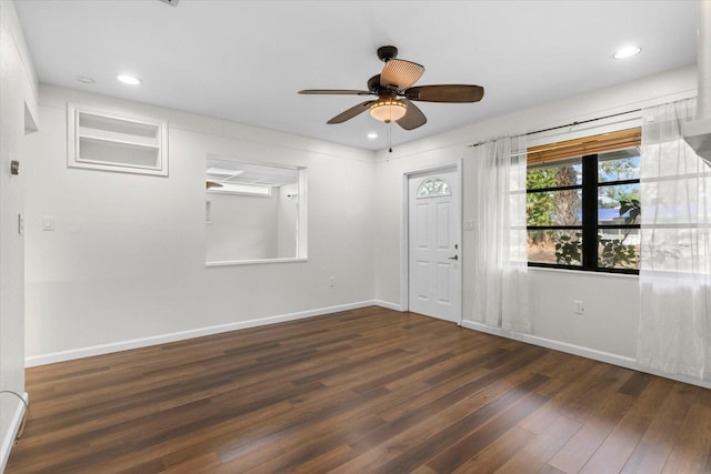 empty room with ceiling fan and dark hardwood / wood-style flooring