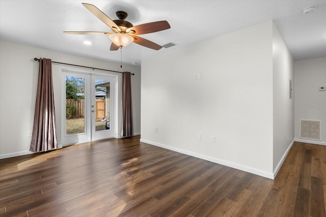 spare room featuring dark hardwood / wood-style floors and ceiling fan