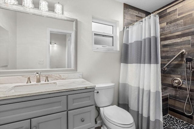 bathroom with vanity, toilet, and walk in shower