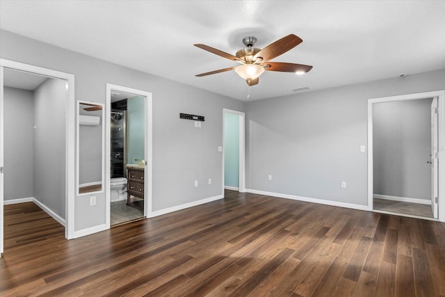 unfurnished bedroom featuring connected bathroom, ceiling fan, and dark wood-type flooring