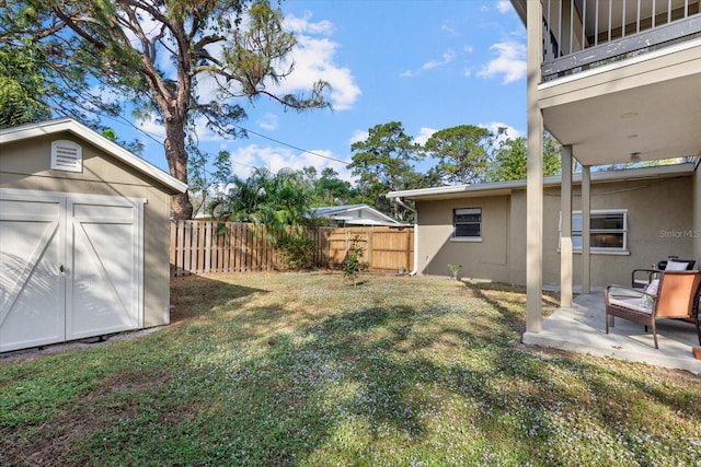 view of yard with a storage shed and a patio