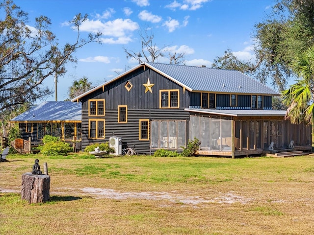 back of house with a yard and a sunroom