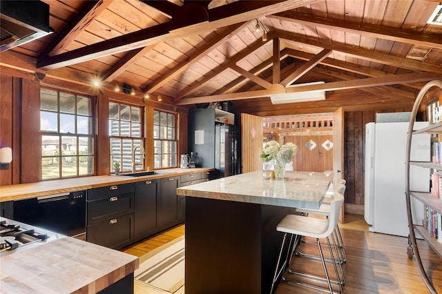 kitchen featuring a kitchen island, light wood-type flooring, and sink