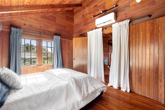 bedroom with an AC wall unit, wood walls, hardwood / wood-style floors, and lofted ceiling with beams