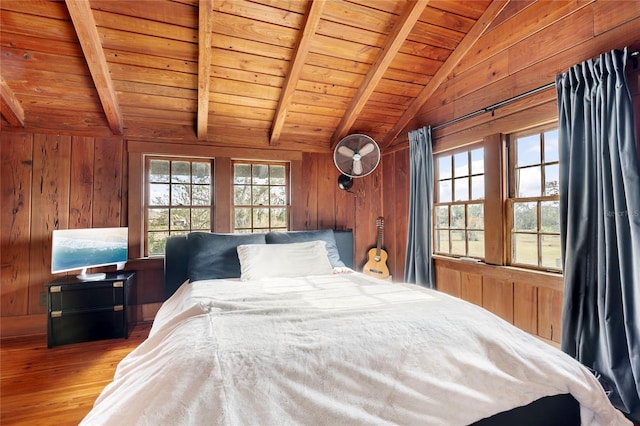 bedroom featuring hardwood / wood-style floors, vaulted ceiling with beams, wooden walls, and wood ceiling