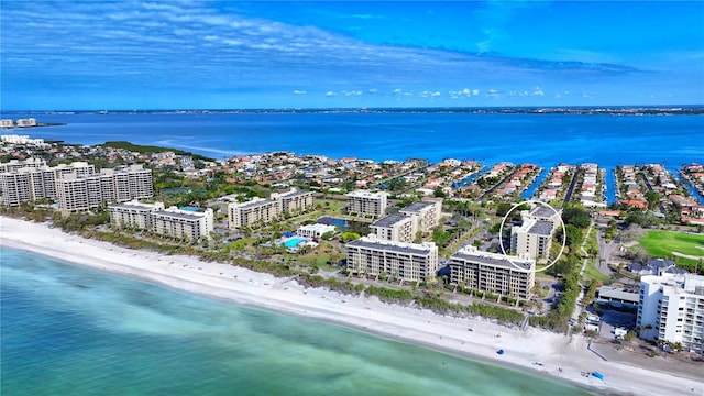 drone / aerial view featuring a water view and a beach view