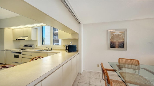 kitchen featuring sink, light tile patterned floors, and white electric range