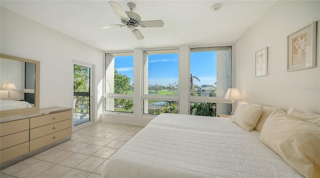 bedroom featuring access to exterior, a textured ceiling, ceiling fan, and light tile patterned flooring