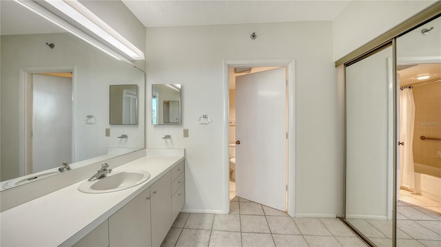 full bathroom featuring tile patterned flooring, vanity, toilet, and shower / bath combo