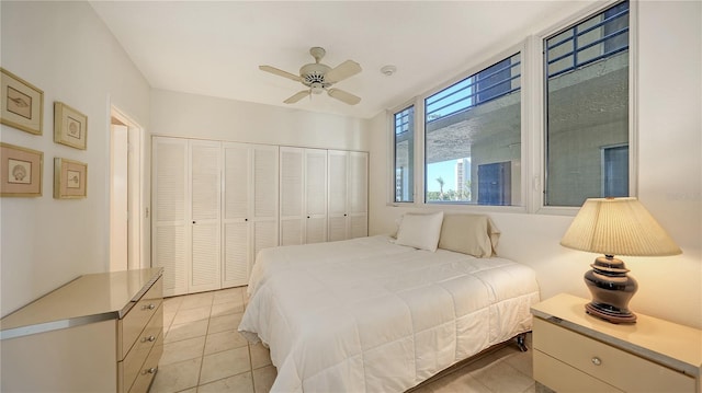 bedroom featuring ceiling fan, light tile patterned flooring, and a closet